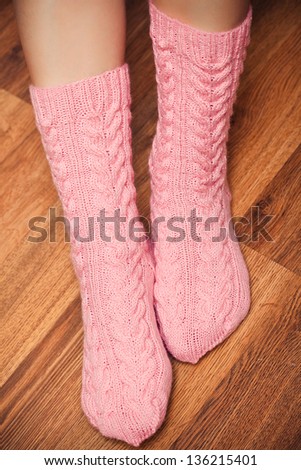 knitted pink socks on woman's feet