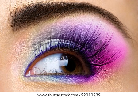 Female eye with colored make-up and long eyelashes
