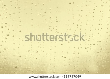Abstract texture: drops of water on yellow gold background. For art texture, grunge design, and vintage paper / border frame
