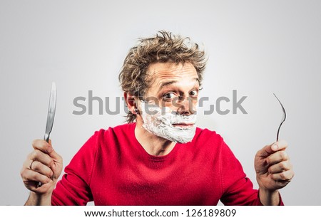 hungry man in the foam with a knife and fork
