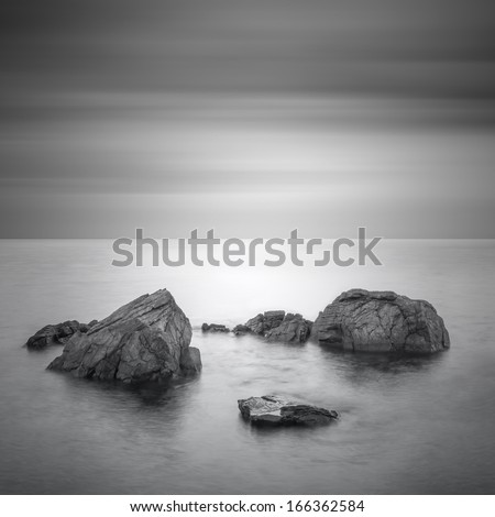Black & White minimalist seascape with rocks. Black sea.