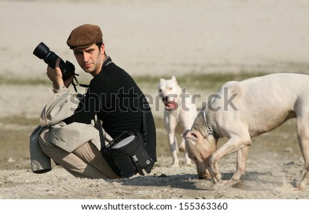 Photographer with his dogs on beach