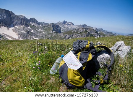 Backpack with map and water on peak