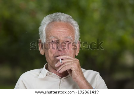 Old man smoking cigarette and enjoying life