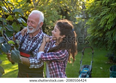 Similar – Image, Stock Photo Senior man pruning branches in back yard