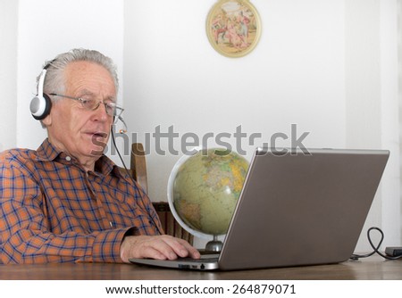 Older man using laptop for internet communication