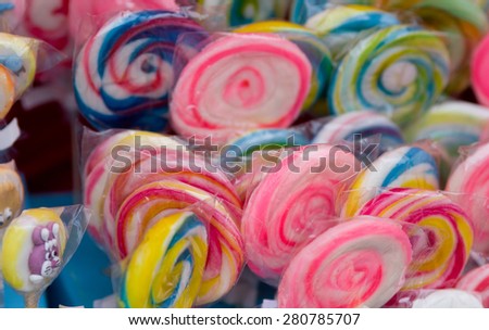 Group of packed colorful round lollipops on the market