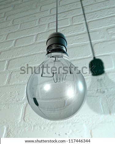 A regular unlit light bulb fitted into a light fitting hanging from a chord on a white washed brick wall