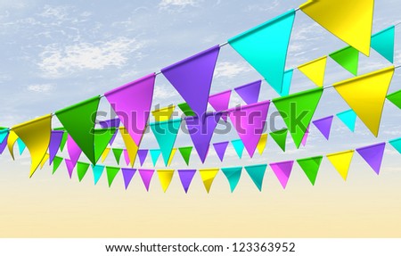 Regular strands of fairground bunting flags in various colors on a blue sky background