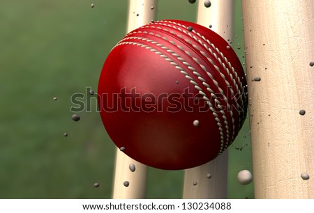 A red leather stitched cricket ball hitting wooden wickets with dirt particles emanating from the impact