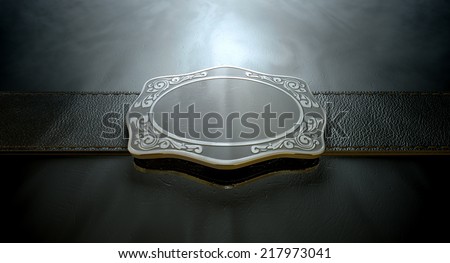 A seamed leather belt threaded through an ornate cast iron belt buckle on an isolated background