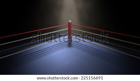 A closeup of the red corner of a regular boxing ring surrounded by ropes spotlit by a spotlight on an isolated dark background