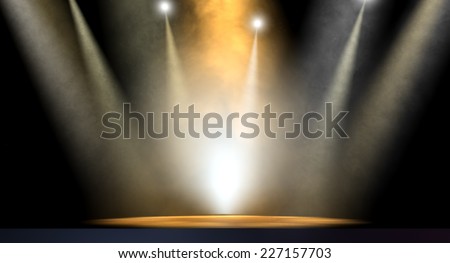 An stage lit by an array of spotlights on a dark background