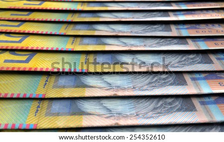 A 3D rendering of a macro close-up view showing the detail of australian dollar banknotes laid out and overlapping in a staggered row
