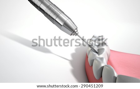 A closeup of a steel dentists drill performing an examination on a set of false teeth on an isolated studio background