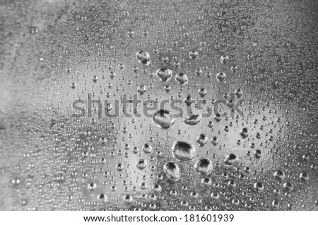 Water drops on a silver shiny background