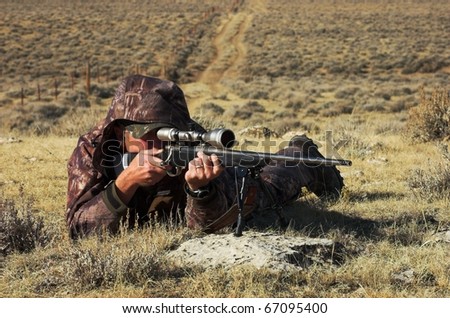 Close up image of male shooting rifle.  Image taken during big game hunting trip in Wyoming.