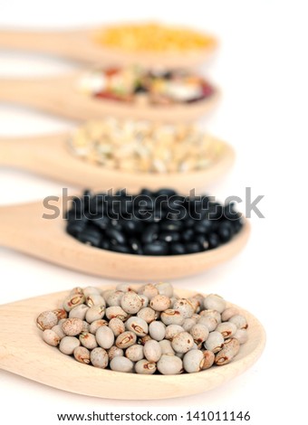 pigeon and other pea on wooden spoon on white background