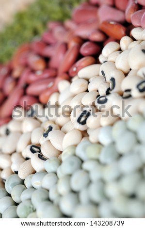closeup of green pea, black eyes and light red bean focus on black eyes bean