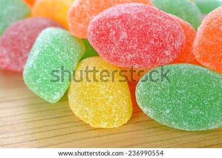 a group colorful gummy candy  on wooden table