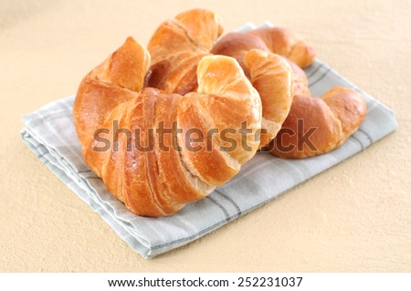 three  delicious croissants on table for breakfast