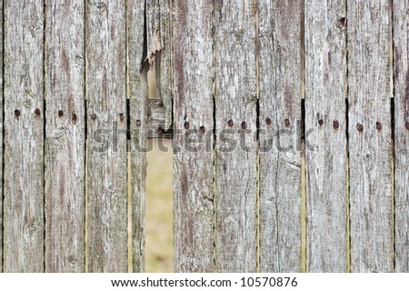 old grunge wood fence with a broken piece
