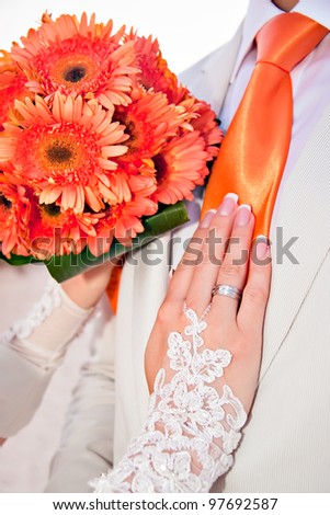 Wedding orange bouquet and tie.