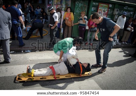 BUENOS AIRES, ARGENTINA - FEB 22: An injured woman is attended by medical personnel after a train crashed at Once train station in Buenos Aires on February 22, 2012.
