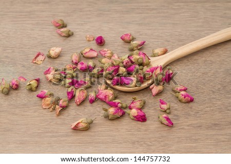 Rose Tea ,dried rose buds tea in wooden spoon