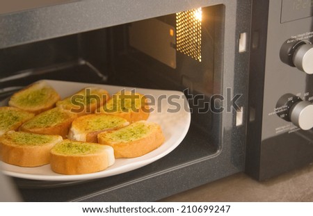 Fresh homemade garlic bread in microwave oven