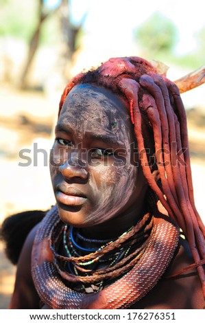 EPUPA, NAMIBIA - MAY 2011: An unidentified Himba woman poses for photographers at a Himba village on May 27th, 2011. Entrance fee to the village is a specified food parcel