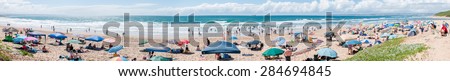 MOSSELBAY, SOUTH AFRICA - DECEMBER 29, 2014: Panorama of unidentified people at a beach in Klein Brakrivier near Mosselbay, South Africa