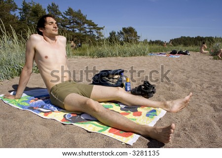 Man tanning on the beach