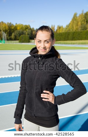 Beautiful woman posing on athletics field