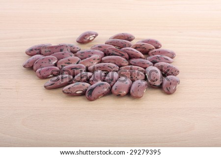 Runner bean seeds on wooden chopping board