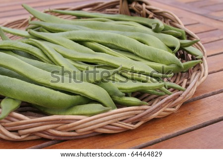 Green runner beans on basket