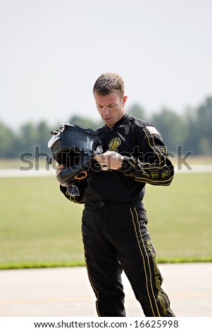 INDIANAPOLIS - AUGUST 24: A member of the Golden Knights Parachute team checks his helmet after landing at the Indy air show on August 24, 2008 in Indianapolis,Indiana