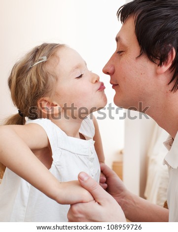Daughter kissing her dad. Happy family