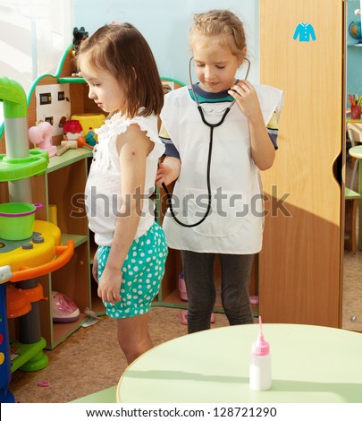 Child in kindergarten. Kids in nursery school. Girl playing at infant school