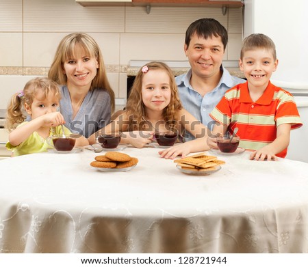 Happy family at breakfast in the kitchen