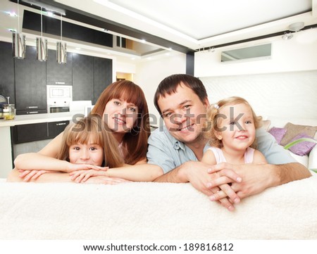 Happy family with two children on sofa
