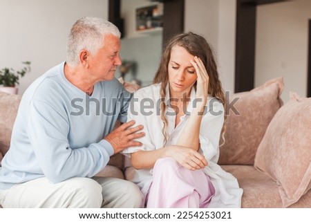 Worried aged father embracing comforting grown up daughter with broken heart family sit on sofa, elderly dad soothe crying adult child, divorce or miscarriage, share problem with someone close concept Foto stock © 