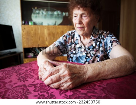 Old woman. Elderly sad female at home