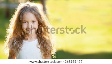 Happy laughing girl on grass. Smiling one child outdoors