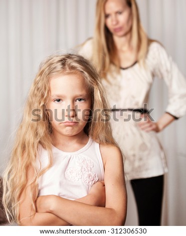 Mom swears by daughter. Conflict, problems in family. Sad mother and child