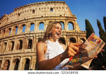 Rome, Italy. Woman with map on the background of the Colosseum. Happy tourist