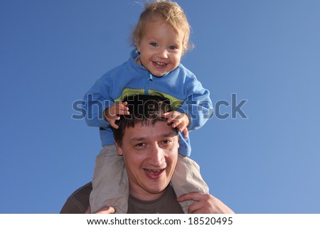 Happy the daddy with a daughter against the sky