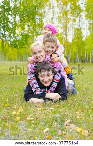Happy family with two children in autumn park