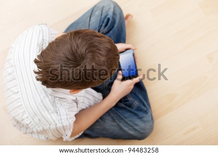 Child with smart phone. Boy play smart phone