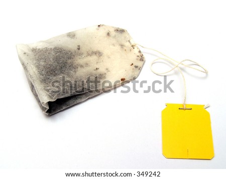 A plain yellow tagged tea bag with clear background